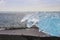 Diamond Beach in Iceland with blue icebergs melting on black sand and ice glistening with sunlight