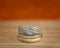 Diamond cluster wedding ring sitting on timber surface