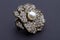 Diamond encrusted brooch with pearl center-piece