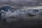 Diamond-like Ice Floats Through Lagoon On Dark Day