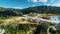 Diamond mine aerial view tracking pushing in flying slow hovering over mountains equipment blue sky