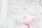 Diamond ring and pink ribbon on pearl necklace background