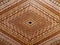 Diamond shaped geometric mosaic marquetry wooden surface.