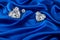 Diamonds on blue luxurious cloth silk, wavy fabric satin and gemstone