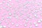 Diamonds, rhinestones on a pastel pink background. Beautiful festive backdrop. Crystals for nail art, makeup, and design