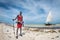 Diani Beach / Kenya - March 01 2020: Masai on the beach in Kenya, Diani Beach, watamu holding an arrow with a sail boat in the bac