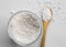 Diatomaceous earth also known as diatomite mixed in glass jar and wood spoon on gray background  studio shot.