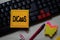 DICaaS - Data Intensive Computing as a Service write on a sticky note isolated on office desk