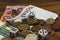 Dice, coins, euro banknotes on a wooden table