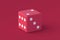 Dice of magenta on red background. Color of the year 2023