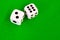 Dice white on green cloth or cloth