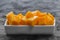 Diced mango cubes placed and served on a white dish closeup