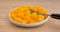 Diced mangos in a dish with fork