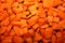 Diced orange carrot pattern. Coarse uniform texture.