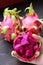 Diced Ripe Pink Pitaya or Red Flesh Dragon Fruit with Blurry Whole Fruits in the Backdrop