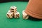 Dices and a gmaing shaker on a green background. Gaming, luck and risk concept