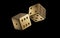 Dices made of gold are flying in the air on a black background