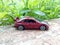 diecast, metal sedan toy cars, miniature red cars in the park and grass