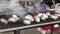 DIEPPE, FRANCE - NOVEMBER 16, 2019: Fair of Herring and scallop shell. Many potatoes in foil on the barbecue