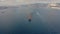 Diesel cargo ship leaves port, aerial drone front top view video