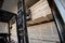 A diesel forklift loads freshly sawn pine logs, girders, bars, beams, bars, boards into a drying chamber.