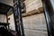 A diesel forklift loads freshly sawn pine logs, girders, bars, beams, bars, boards into a drying chamber.