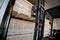 A diesel forklift loads freshly sawn pine logs, girders, bars, beams, bars, boards into a drying chamber. Industrial technology of