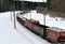 Diesel locomotive with wagons locomotive rides by rail in winter