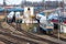 Diesel locomotives with wagons are in the depot with railroad arrows and rails. Ð¡oncept of passenger transportation and travel