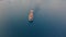 Diesel ship smoking in harbor, aerial drone front top view video.