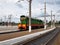 Diesel shunting locomotive of green and red colors stands near Peron. Tractor train of Soviet times. Infrastructure transport rout