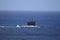 Diesel submarine passing by on blue ocean