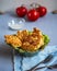 Diet Breakfast of chicken cutlets and fresh vegetables, napkin and Cutlery on a gray background