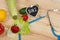 diet concept - Blackboard in shape of heart with text BMI Body mass index, stethoscope, vegetables, fruits and berries