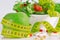 Diet concept - green apples, lettuce, pills and measure tape