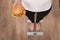 Diet And Fast Food Concept. Overweight Woman Standing On Weighing Scale Holding Burger ( Hamburger ). Unhealthy Junk Food.