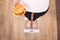 Diet And Fast Food Concept. Overweight Woman Standing On Weighing Scale Holding Burger Hamburger . Unhealthy Junk Food. Dieting