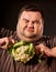 Diet fat man eating healthy food. Healthy breakfast vegetables cauliflower.