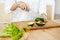 Diet. Female Hands Cutting Avocado In Kitchen.