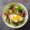 Diet food tuna salad with boiled egg, canned fish, onion and green lettuce