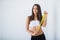 Diet. The girl taking measurements of her body, white background