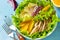 Diet menu. Healthy salad close-up, salad with chicken, egg pancakes, orange, green salad and dressing vinaigrette.