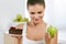 Diet And Nutrition. Woman Choosing Between Cake And Apple.