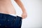 This diet is paying off. Cropped image of a woman pulling the waistband of her pants - Weight Loss.