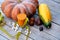 Diet pumpkin juice. A huge pumpkin with vegetables lies next to a glass of natural pumpkin juice and a centimeter-long ribbon