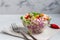 Diet salad made from fresh vegetables. Peking cabbage lilac and green, tomatoes, green onions and chili peppers. Dressed with