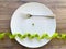 Diet. Suffering from anorexia. Cropped image pea on white plate, with fork and measuring