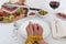 Diet for weight loss: table laden with food with hands sealed by tape measure