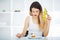 Diet. Woman hungry girl with yellow measuring tape holds in hand