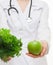 Dietarian proposing fresh greens and a green apple for you